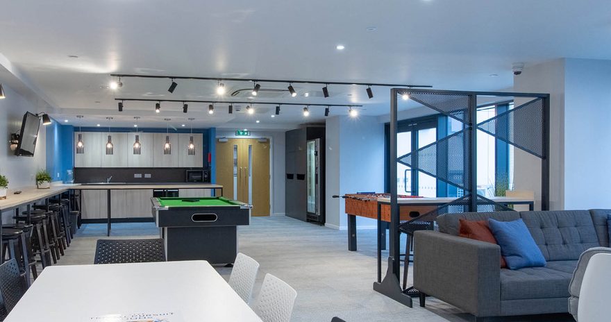Games room with a table football, pool table and seating area at oxford point in Bournemouth