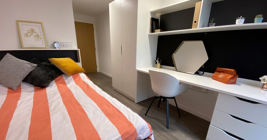 The small double bed and study desk of the silver plus ensuite at oxford point in bournemouth