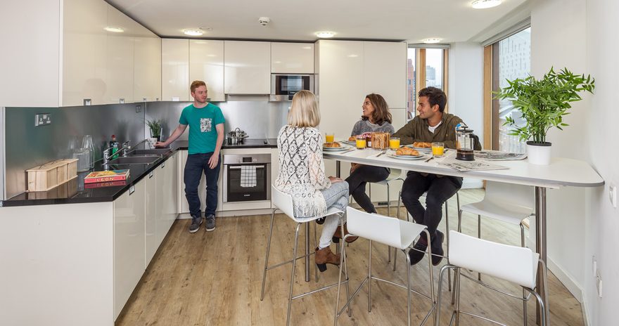 Student in a fully equipped shared kitchen at the Urbanest Hoxton accommodation