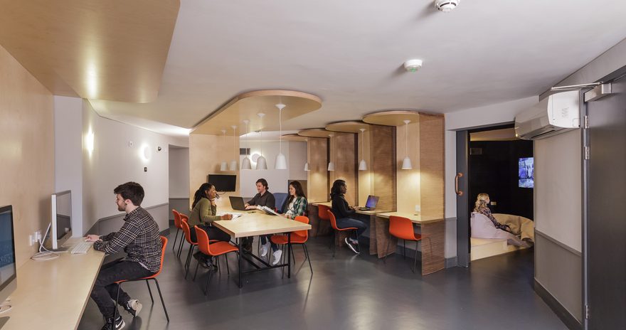 The study space at Urbanest Tower Bridge with students meeting at a central table and studying at desks on the side