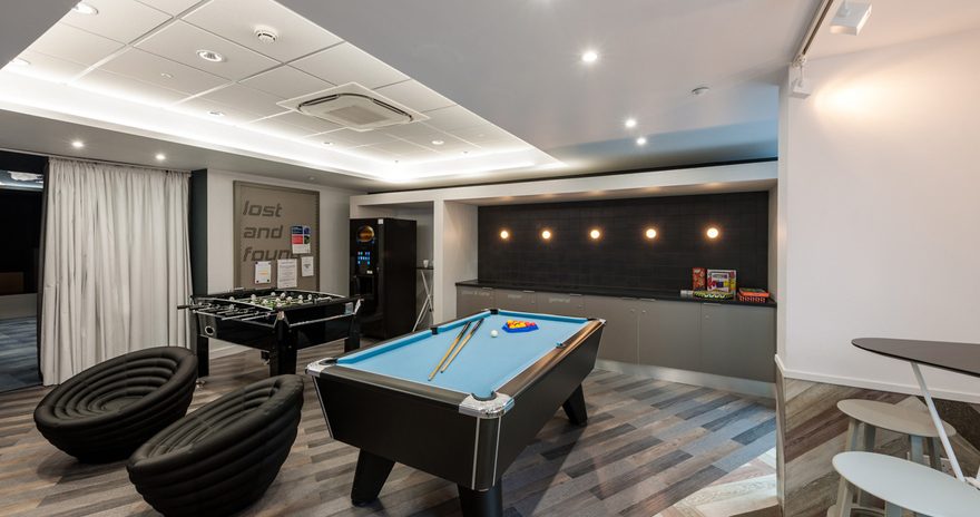 the games room containing a table football, a pool table and a vending machine at the West Village residence