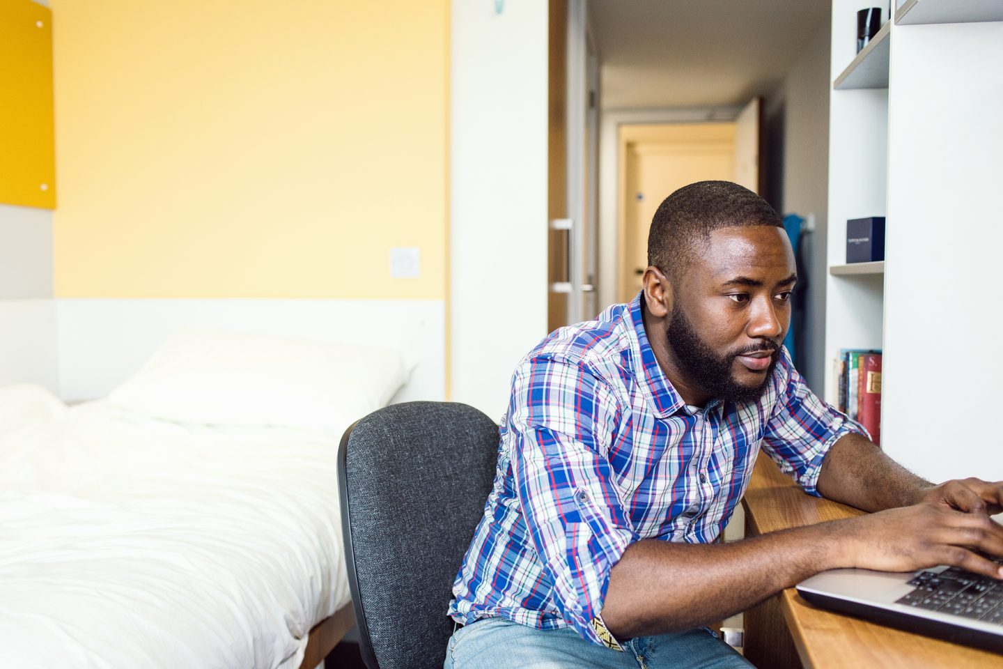 Student at a study desk using a laptop