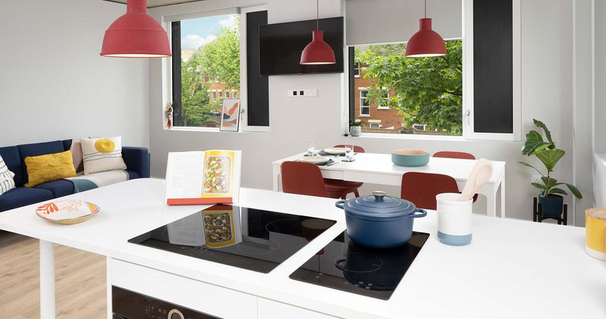 A shared kitchen at Scape Canada Water with worktop, table, chairs and a sofa