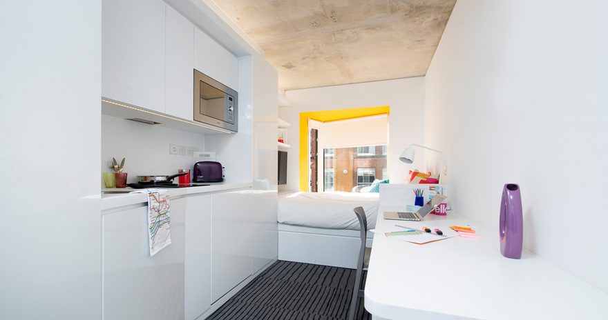 A studio flat at Scape Shoreditch with a study desk, bed and window