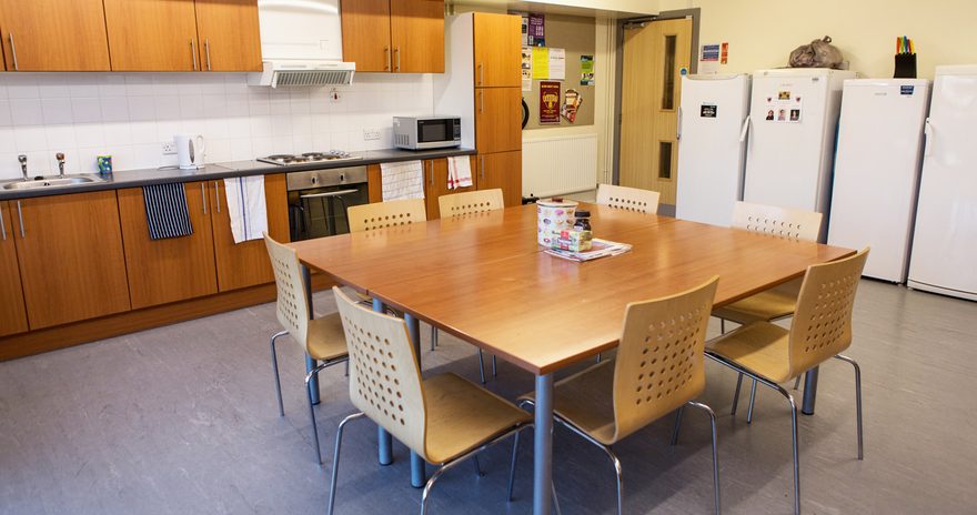 the shared kitchen with table, chairs and fridge-freezers at the alcuin college