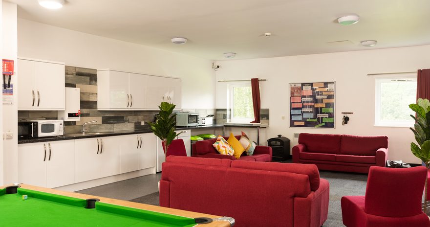 Social space with sofas, shared kitchen and pool table
