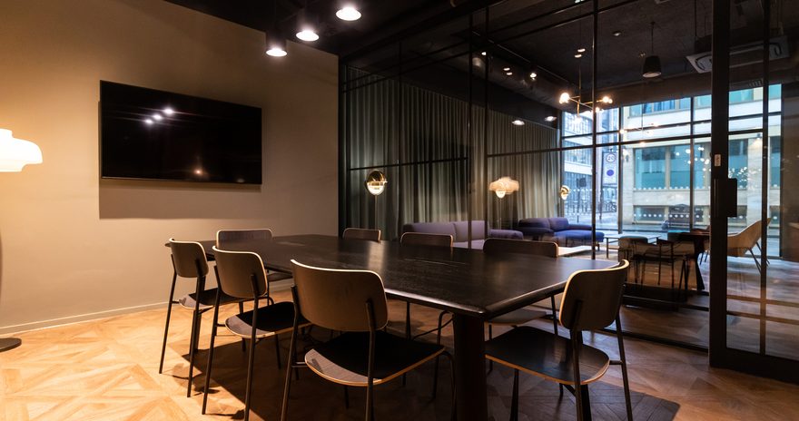 Meeting room with dark tonal colours with space for up to 8 people