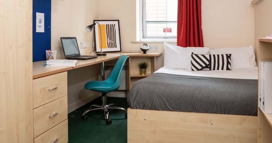 Double bed and built-in desk at the Albert Court student accommodation