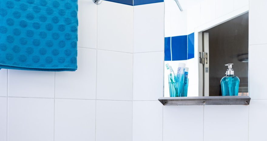 En-suite washroom with touches of blue toiletries and towel