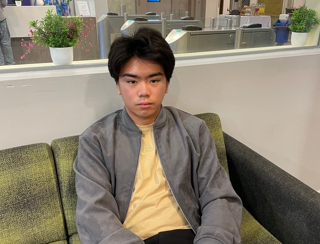 A UNIC student sitting on the sofa